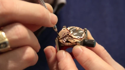 Watchmaker working on an open watch movement