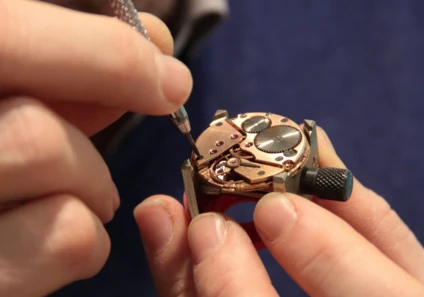 Watchmaker working on an open watch movement